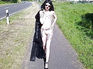 Shameless slut walks nude on a public road