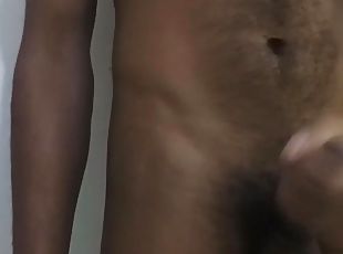 Young male masturbation on a camera behind a white background 