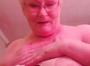 Dirty granny granny plays with her huge boobs and shows her bunny tail for you