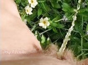 Girl watering Wild Flowers with her Pee on the Roadside